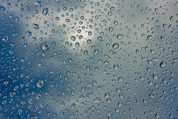 istock Drops of rain on glass , rain drops on clear window 595318408