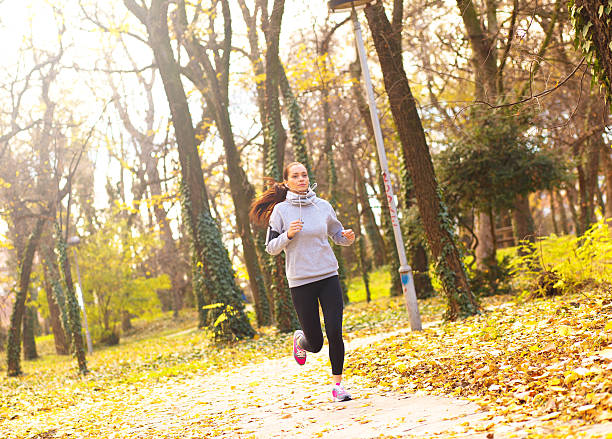 istock Sporty young woman running outside. 595320172