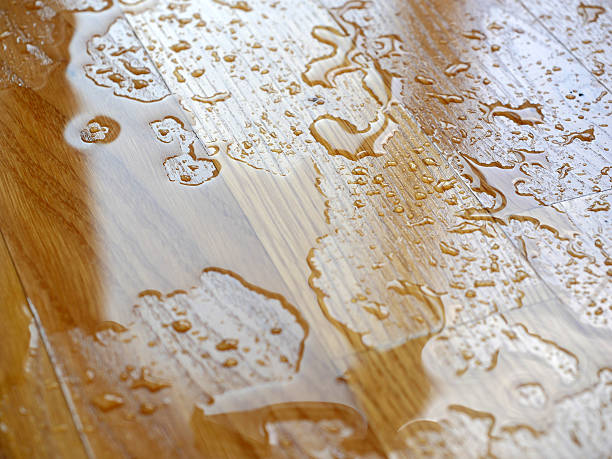 istock Parquet. Water drops on wooden surface. 595322084