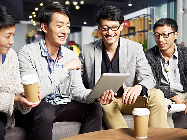 istock young asian business people using tablet in office 595324264