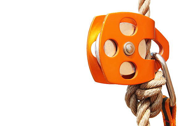 Orange Climbing Pulley with rope and carabiner (isolated) stock photo