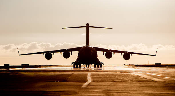 istock Large military cargo plane silhouette 595324642