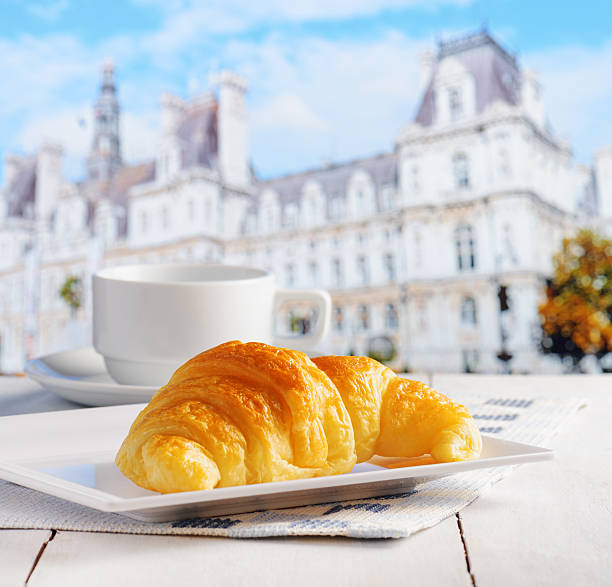 istock Cup of coffee and croissant 595325056
