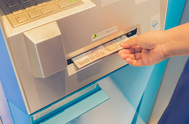 istock Female hand withdrawing money from credit card 595325896