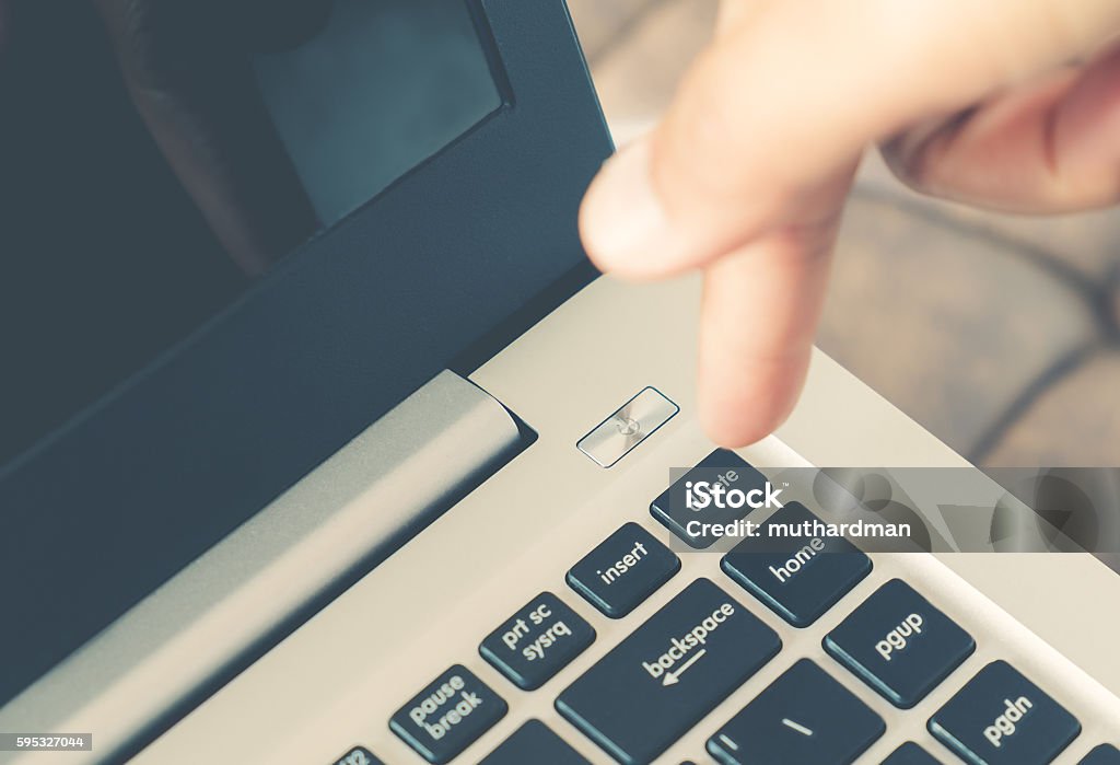 Delete button on laptop computer Closeup image of finger pushing delete button on laptop computer. Laptop Stock Photo