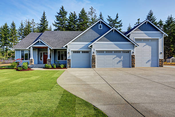 istock Luxury blue house with curb appeal. Three car garage. 595328224
