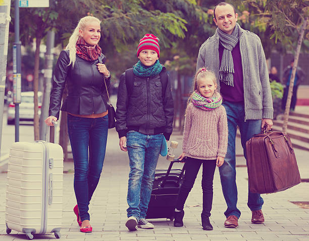 istock Parents with two kids chasing streets 595329288