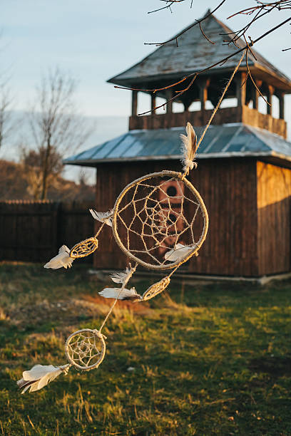 istock Dreamcatcher hangs on a tree near a wooden Fortress 595331386