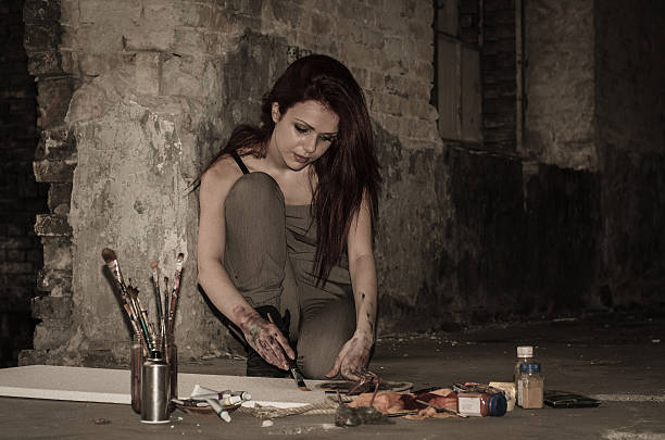 istock Girl painter working in the dark overtime 595331930