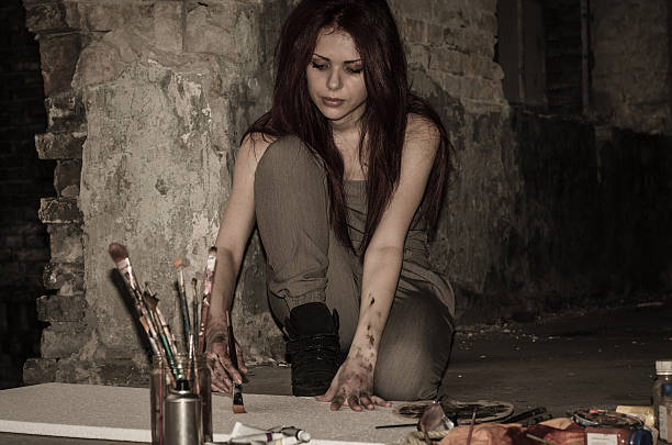 istock Girl painter working in the dark overtime 595332052