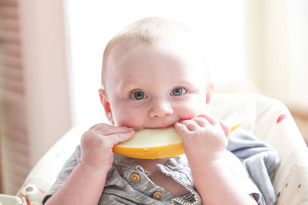 istock Baby Boy eating a Melon Slice 595332220