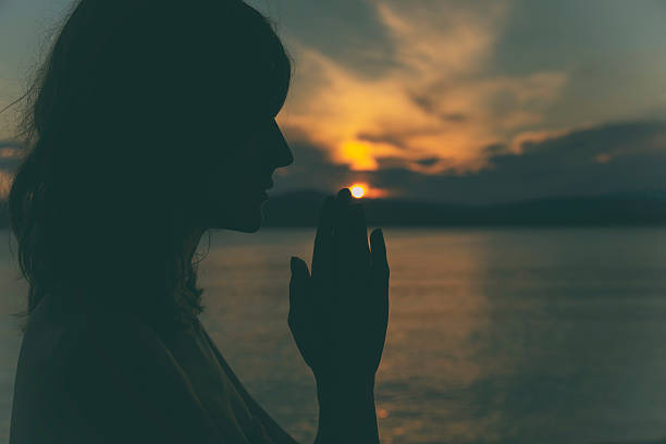 istock Young woman practicing yoga on the beach. 595332264