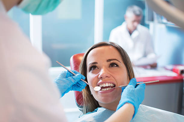 istock Dentist examining a patient's teeth in the dental office. 595332598