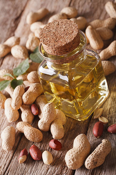 istock Aromatic natural peanut oil in a glass jar closeup 595333640