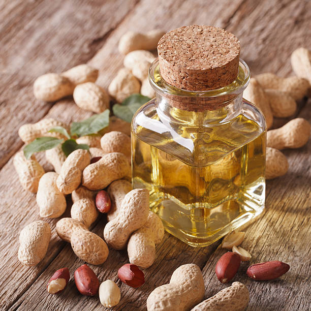 istock Aromatic natural peanut oil in a glass jar close up 595333896