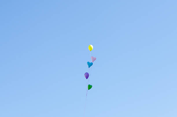 istock Heart-shaped balloons in the sky 595334228