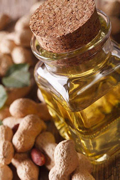 istock Fresh peanut oil in a bottle macro. vertical 595334574