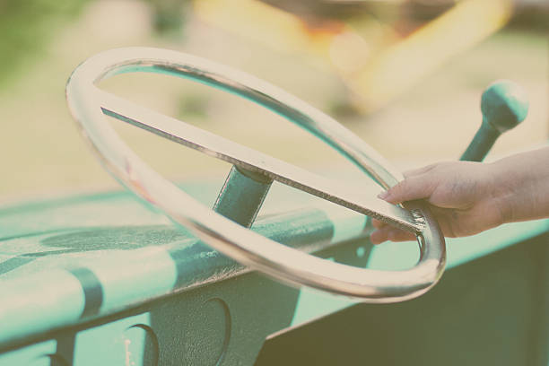 istock Child's hand on the steering wheel 595334660
