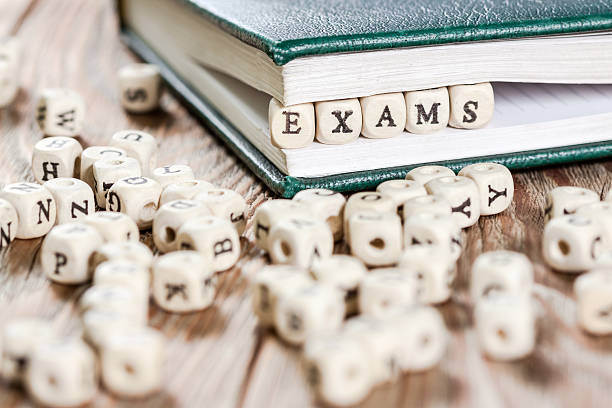 istock Exams word written on a wooden block. 595335032