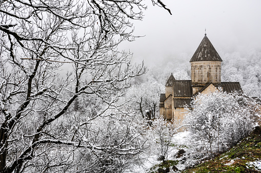 Haghartsin Monastery near small town Dilijan in Armenia. Hidden in winter forest covered with snow.