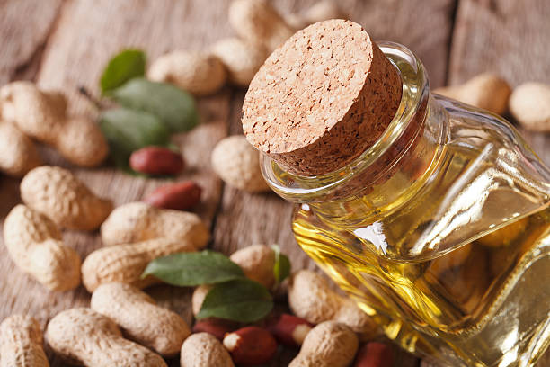 istock Healthy peanut oil in a jar macro. horizontal 595335154