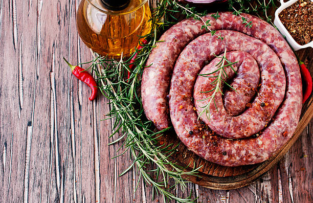 istock raw beef sausages on a cast-iron pan, selective focus 595335314