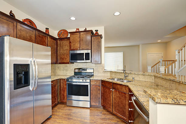istock Kitchen interior with steel appliances and granite counter tops 595335454