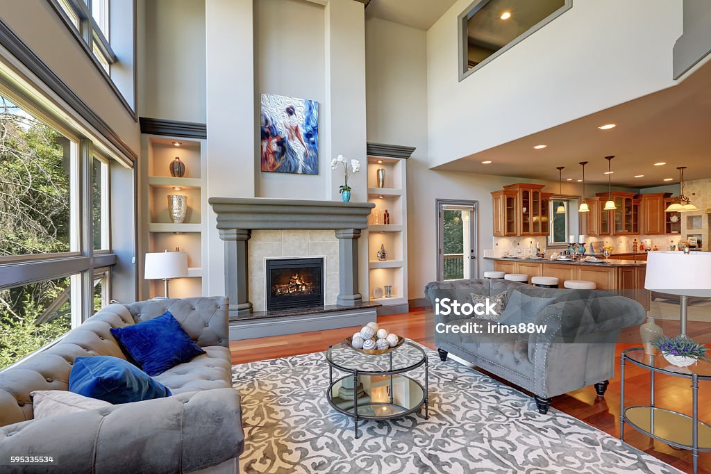 Grey interior of high vaulted ceiling family room. Grey interior of high vaulted ceiling family room in luxury house. Northwest, USA. Living Room Stock Photo