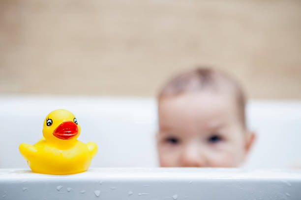 istock Rubber duck over the bathtube 595336074