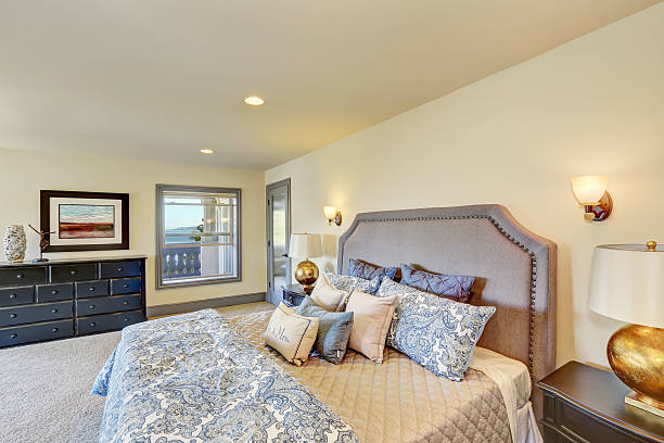 istock Elegant white bedroom with queen size bed and nightstands. 595336918