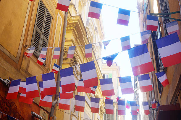 French flag bunting French flag bunting having in a small street in the city of Nice bastille day stock pictures, royalty-free photos & images