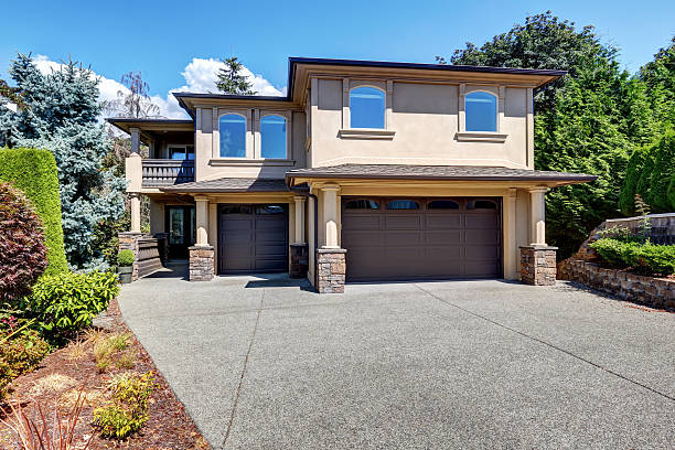 istock Luxury house exterior with columns and brown garage doors. 595338002