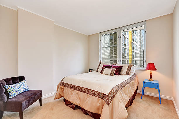 istock Simple beige bedroom interior with brown and creamy tones bed. 595338632