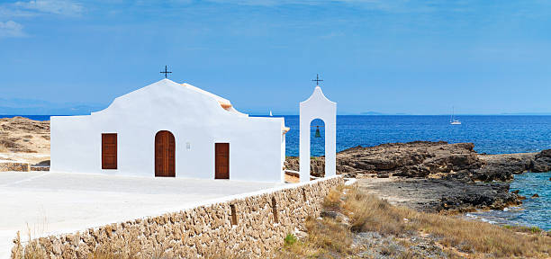 istock Agios Nikolaos. Small white Orthodox church 595339784