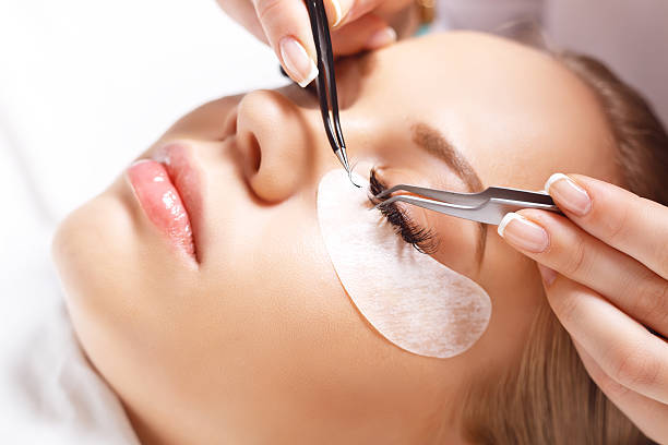 istock Eyelash Extension Procedure. Woman Eye with Long Eyelashes. Lashes. 595340028