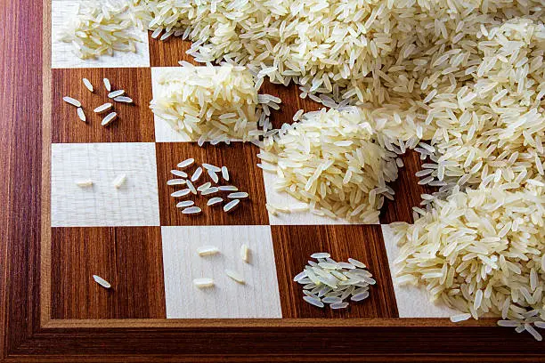 chessboard with exponential growing heaps of rice grains, concept of unlimited growth