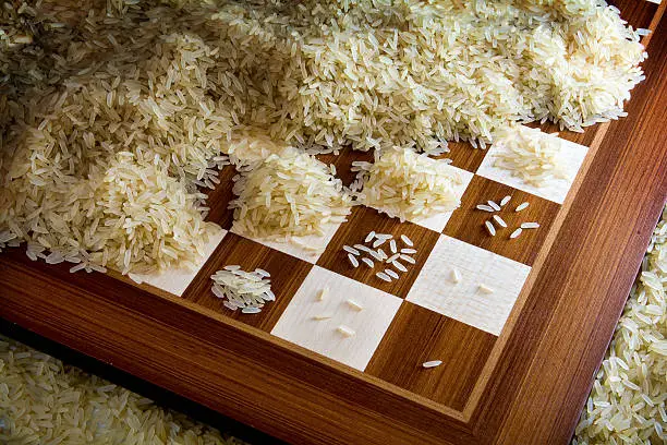 chessboard with exponential growing heaps of rice grains, legendary metaphor of unlimited growth