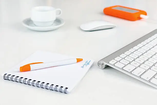 Photo of Business Composition on white Desk orange Items