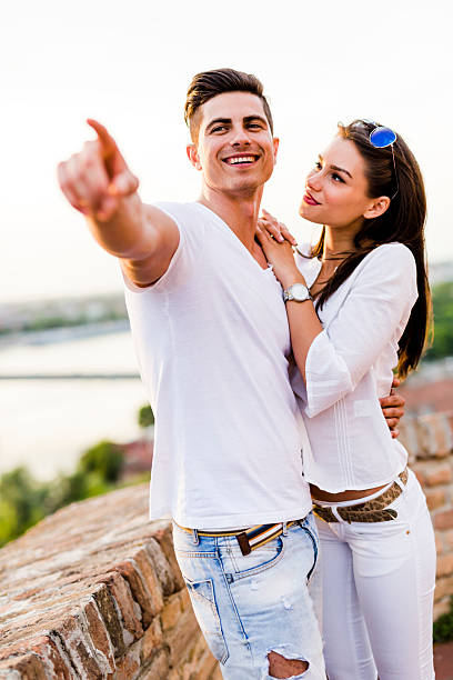 istock Happy couple pointing in a direction 595341144