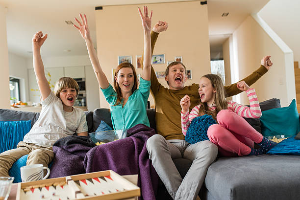 istock Family watching TV and cheering 595341834