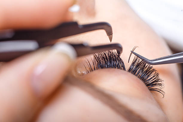 istock Eyelash Extension Procedure. Woman Eye with Long Eyelashes. Lashes. 595341904
