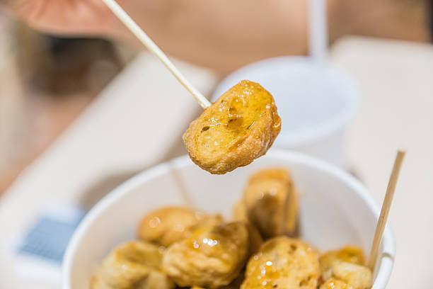 istock Hand Holding Meatball on Toothpick 595342180