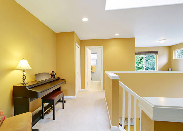istock Bright hallway interior with yellow walls and piano 595343970
