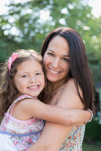 istock Portrait smiling mother holding daughter 595347669