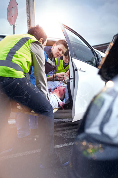 Firefighters helping a car accident victim