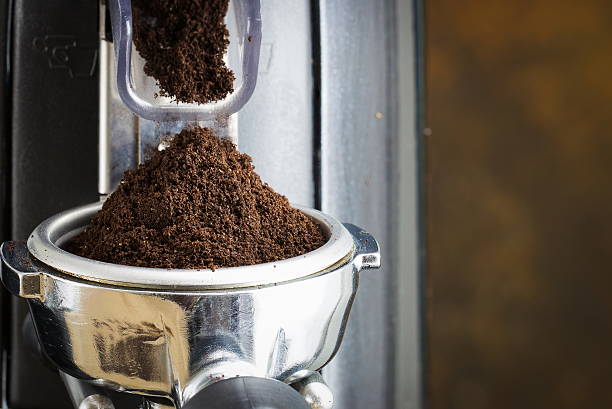 istock coffee grinder grinding freshly roasted coffee beans into a coff 595351122