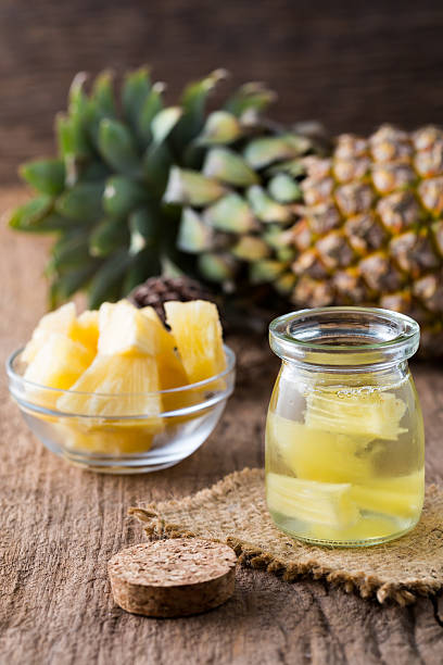 istock Pineapple juice and slices on wooden table 595351172