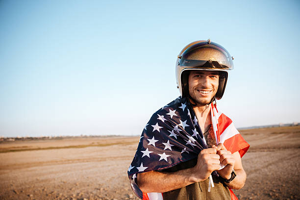 istock Man wearing american flag cape and golden looking at camera 595352066