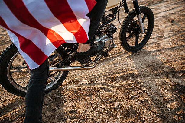 istock Cropped image of men leg starting motorcycle 595352208