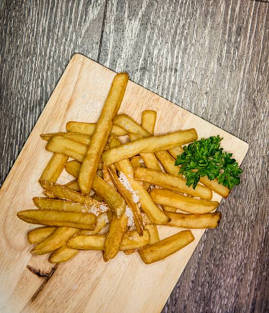 istock French fries on a wooden background 595353308